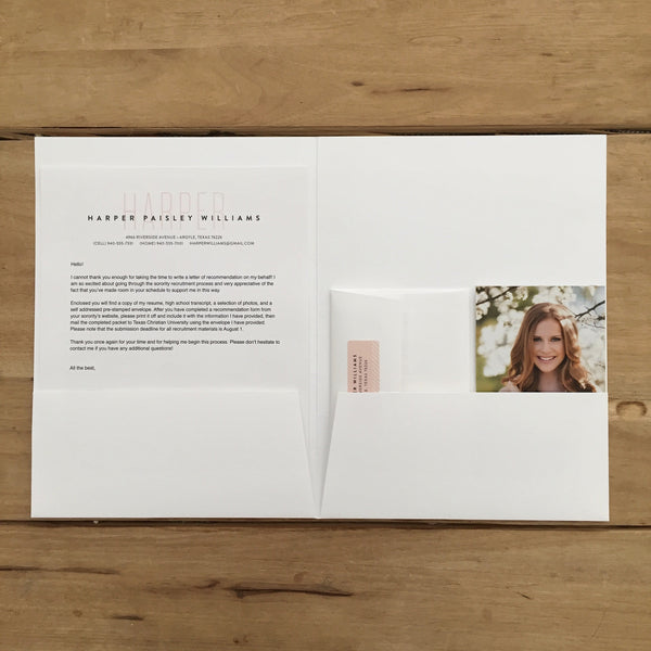 White pocket folder holding contents of a sorority packet